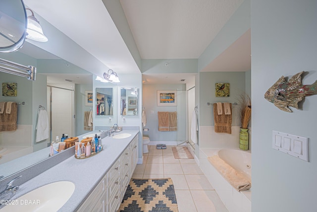 full bathroom featuring a stall shower, a sink, and tile patterned floors