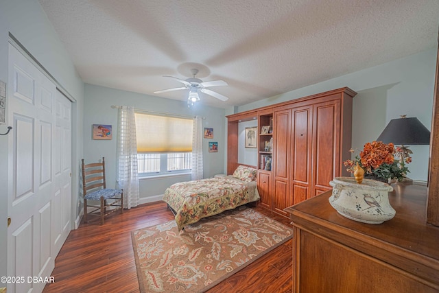 bedroom with a ceiling fan, a closet, dark wood finished floors, and a textured ceiling