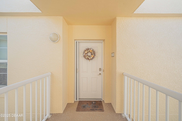 entrance to property with stucco siding