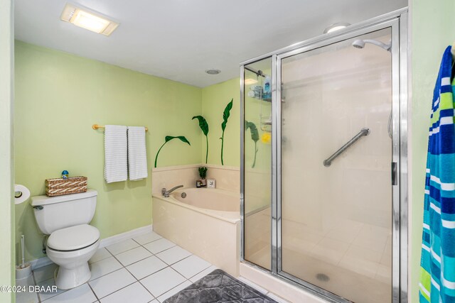 bathroom featuring tile patterned flooring, toilet, and separate shower and tub