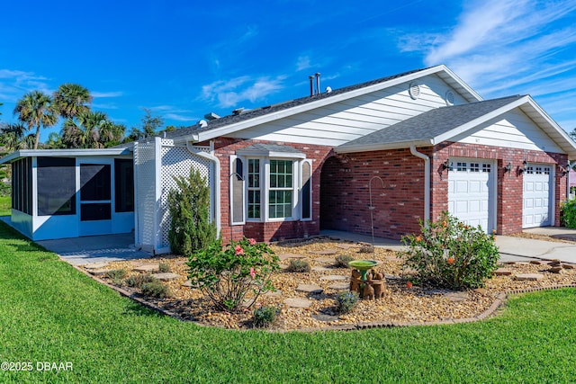 view of front of home featuring a garage, brick siding, a shingled roof, a sunroom, and a front yard