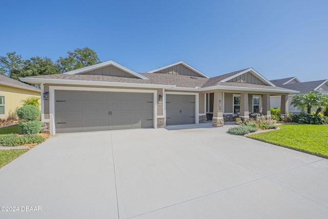 view of front of home with a garage and a front lawn