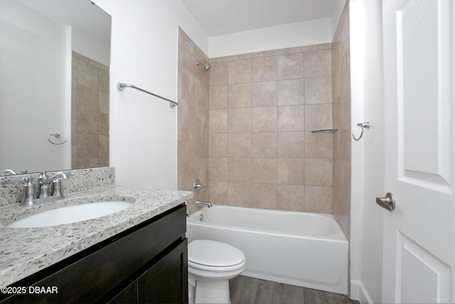 full bathroom featuring wood-type flooring, vanity, toilet, and tiled shower / bath