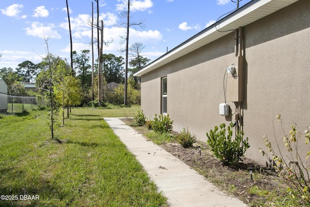 view of side of property with a yard