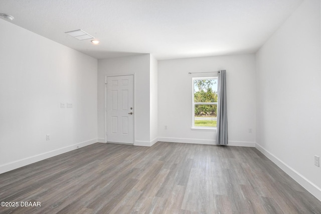 unfurnished room featuring hardwood / wood-style flooring