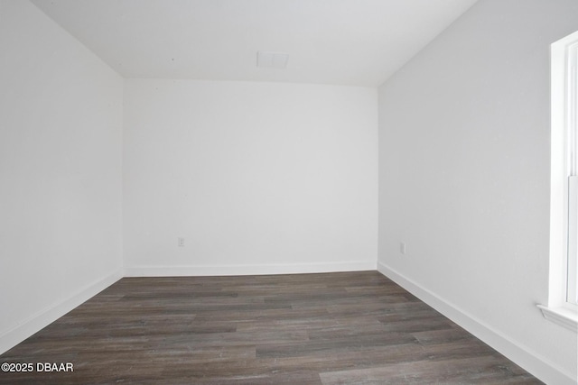 empty room featuring dark wood-type flooring