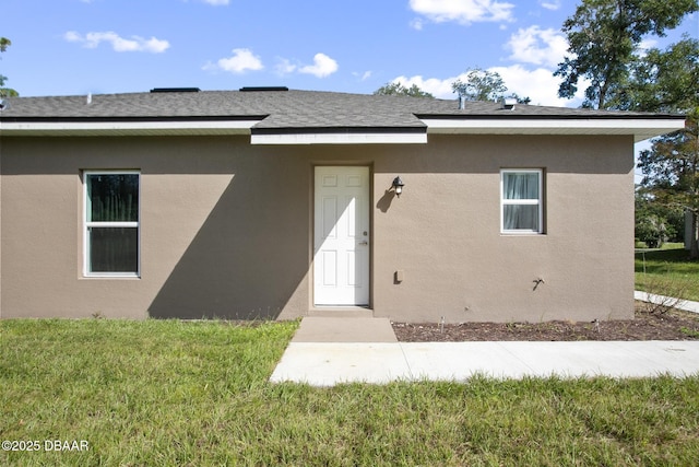 back of property featuring a lawn