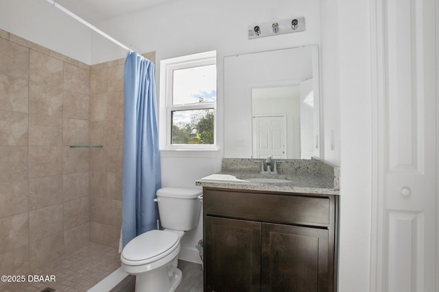 bathroom featuring vanity, toilet, and walk in shower