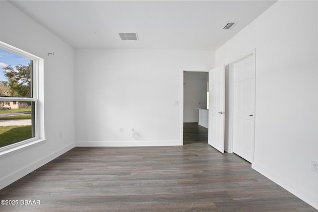 empty room with dark hardwood / wood-style flooring