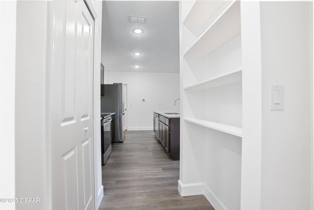 corridor featuring sink and light hardwood / wood-style flooring