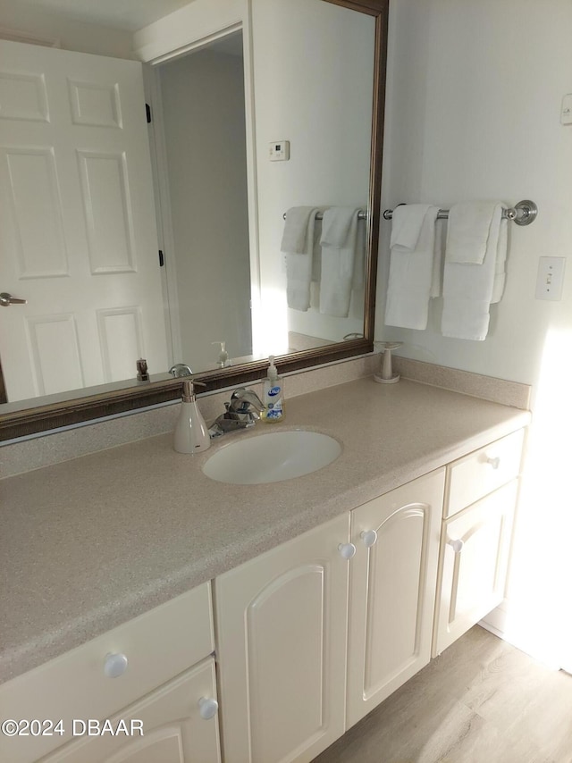 bathroom with hardwood / wood-style floors and vanity