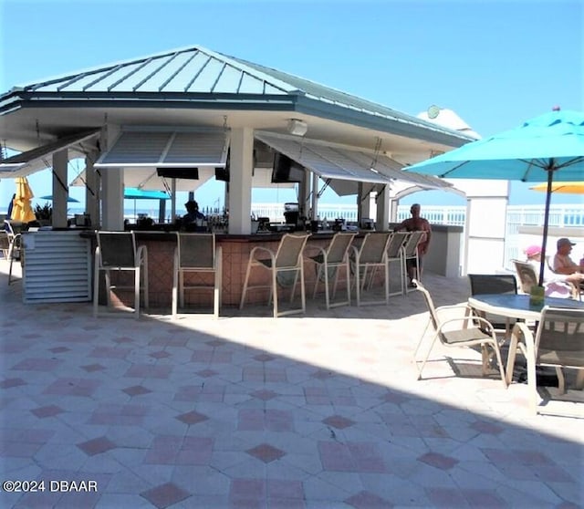 view of patio with an outdoor bar