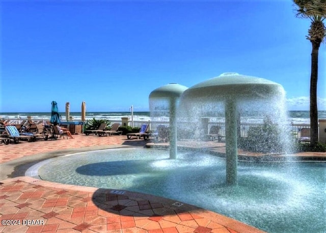 view of pool with a water view