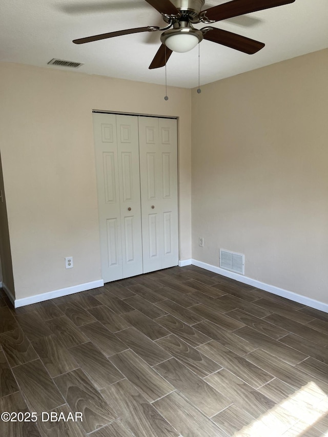 913 New Castle Ct, Holly Hill, FL 32117 - unfurnished bedroom with wood finish floors, a closet, and a ceiling fan