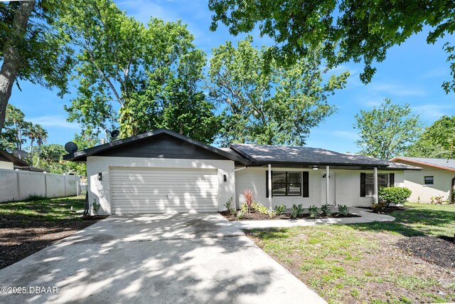 1972 Red Cedar Cir S, Daytona, FL 32119 - ranch-style house with a garage, concrete driveway, and brick siding