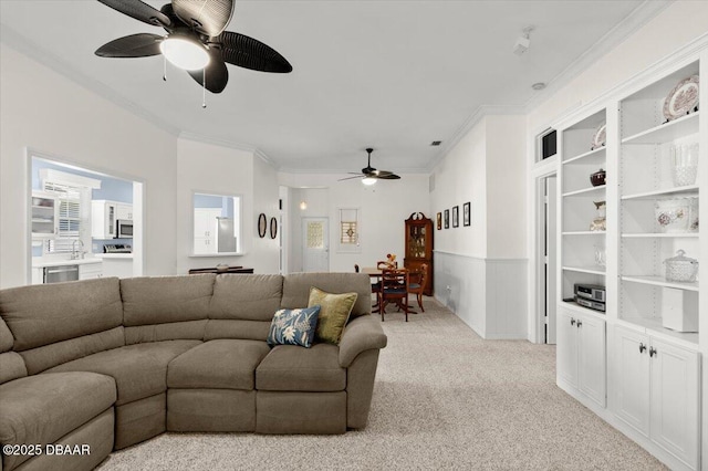 3356 Newbliss Cir, Ormond Beach, FL 32174 - living room featuring light carpet, a wainscoted wall, a ceiling fan, and ornamental molding