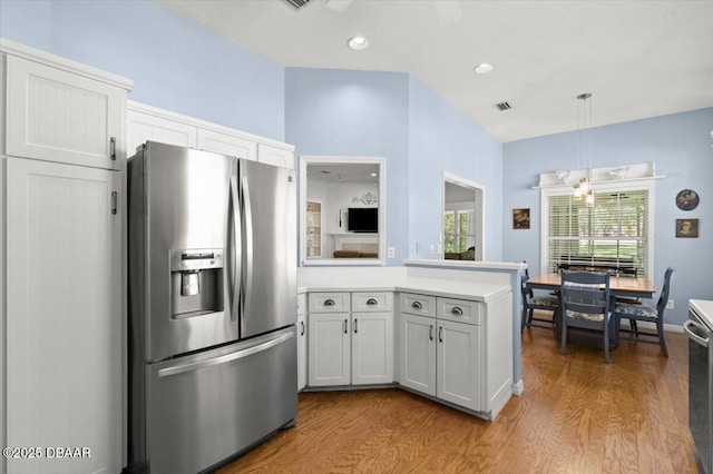 3356 Newbliss Cir, Ormond Beach, FL 32174 - kitchen featuring visible vents, light countertops, a peninsula, wood finished floors, and stainless steel fridge