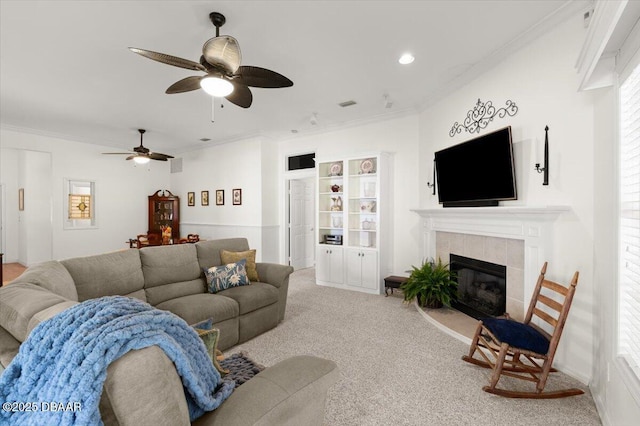 3356 Newbliss Cir, Ormond Beach, FL 32174 - living area with a tiled fireplace, ceiling fan, carpet, and ornamental molding