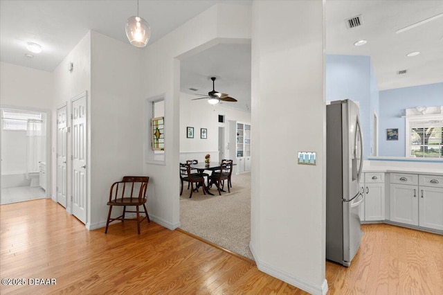 3356 Newbliss Cir, Ormond Beach, FL 32174 - hallway with light wood finished floors, visible vents, and baseboards