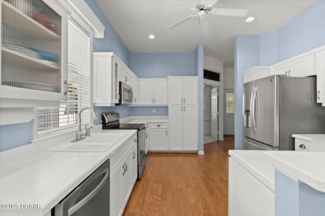 3356 Newbliss Cir, Ormond Beach, FL 32174 - kitchen with a ceiling fan, a sink, white cabinetry, stainless steel appliances, and light countertops