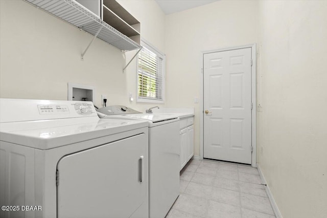 3356 Newbliss Cir, Ormond Beach, FL 32174 - clothes washing area with baseboards, cabinet space, and washing machine and clothes dryer