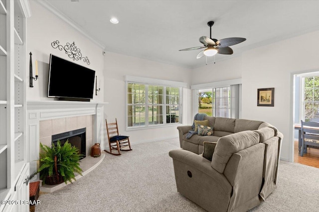 3356 Newbliss Cir, Ormond Beach, FL 32174 - living area with a tiled fireplace, plenty of natural light, a ceiling fan, and ornamental molding