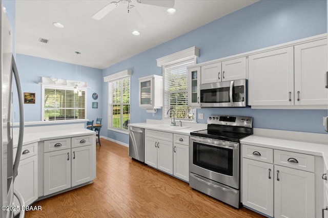 3356 Newbliss Cir, Ormond Beach, FL 32174 - kitchen with light countertops, ceiling fan with notable chandelier, appliances with stainless steel finishes, and a sink