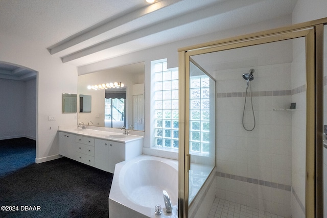 bathroom featuring tile patterned flooring, vanity, and shower with separate bathtub