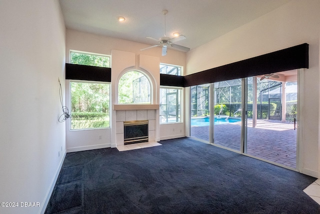 unfurnished living room featuring plenty of natural light and carpet