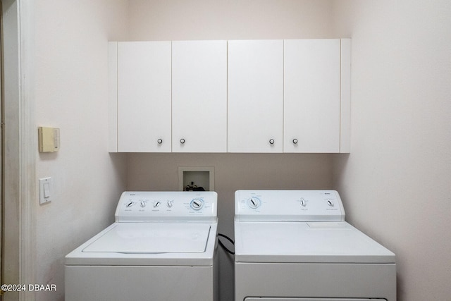 laundry area featuring cabinets and separate washer and dryer