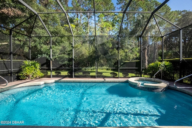 view of swimming pool featuring a lanai and an in ground hot tub