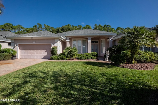 view of front of house with a garage and a front yard