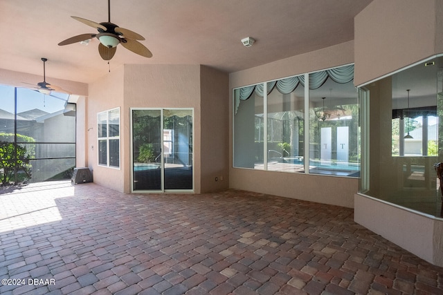 unfurnished sunroom with a wealth of natural light and ceiling fan