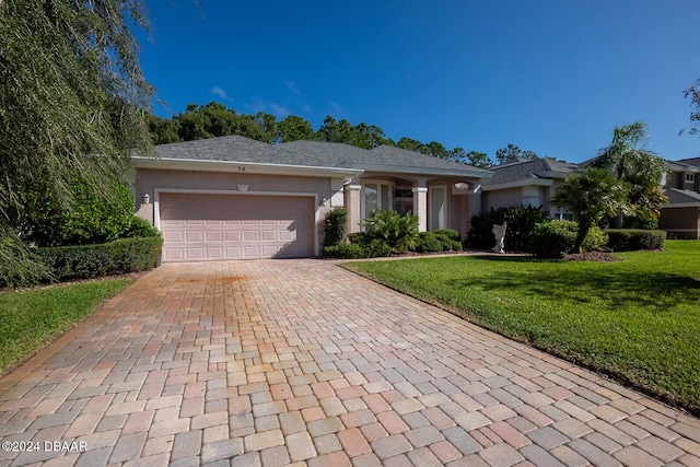 view of front of home featuring a garage and a front yard