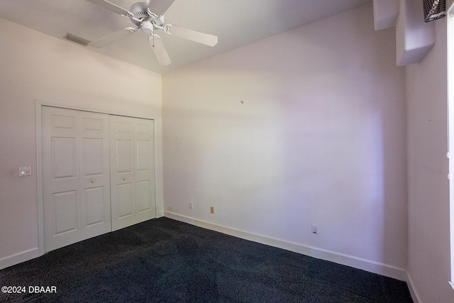 unfurnished bedroom featuring carpet, ceiling fan, and a closet