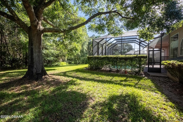 view of yard with glass enclosure