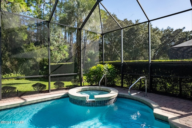 view of swimming pool with a lanai, a patio, and an in ground hot tub