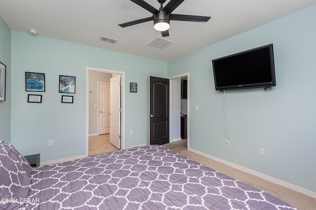 unfurnished bedroom with a textured ceiling, light colored carpet, and ceiling fan