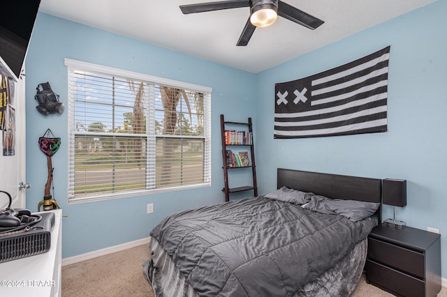 bedroom featuring ceiling fan and light carpet