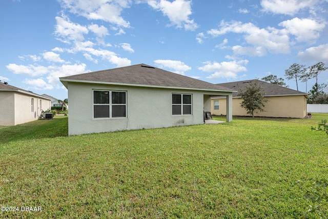 back of house featuring central AC unit, a lawn, and a patio