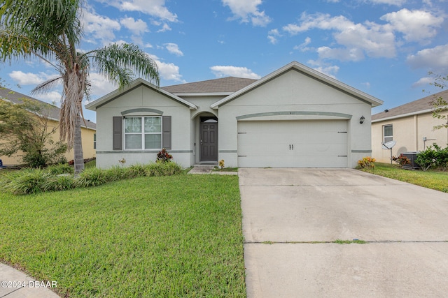 ranch-style home featuring a garage and a front yard