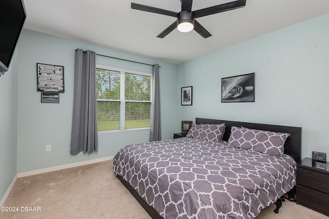 bedroom with light carpet and ceiling fan