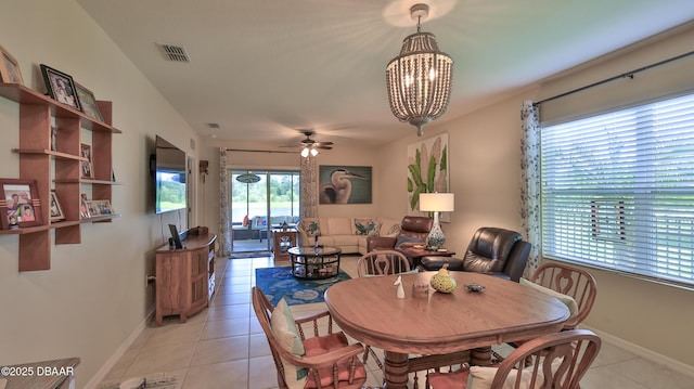 551 Armoyan Way, New Smyrna Beach, FL 32168 - dining space with light tile patterned floors, a ceiling fan, and a chandelier