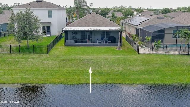 551 Armoyan Way, New Smyrna Beach, FL 32168 - rear view of house featuring a sunroom, a fenced backyard, a water view, and stucco siding