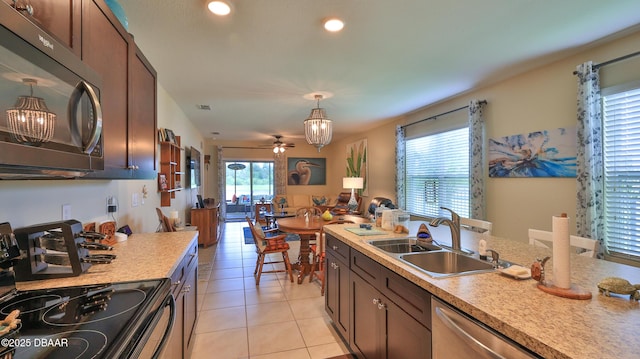 551 Armoyan Way, New Smyrna Beach, FL 32168 - kitchen featuring black microwave, electric stove, light countertops, light tile patterned flooring, and stainless steel dishwasher