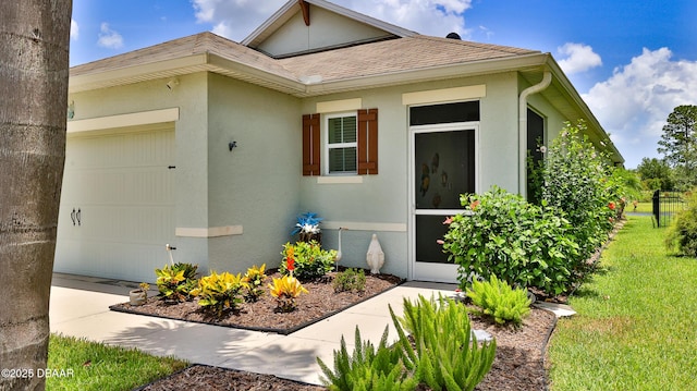 551 Armoyan Way, New Smyrna Beach, FL 32168 - view of home's exterior with an attached garage, stucco siding, a yard, and a shingled roof