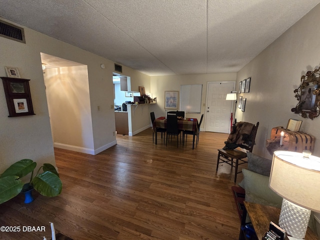 633 S Palmetto Ave Unit 202, Daytona Beach, FL 32114 - living room with baseboards, a textured ceiling, visible vents, and wood finished floors