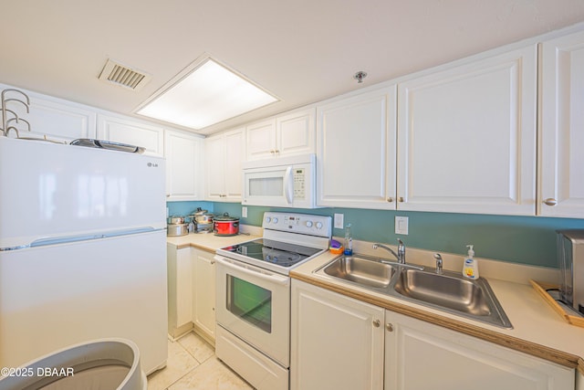 4641 S Atlantic Ave Unit 107, Ponce Inlet, FL 32127 - kitchen with white appliances, a sink, light countertops, and white cabinets