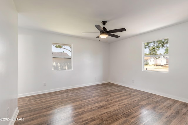 spare room with dark hardwood / wood-style flooring and ceiling fan