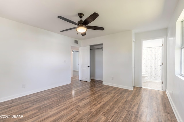 unfurnished bedroom with connected bathroom, ceiling fan, and dark hardwood / wood-style floors